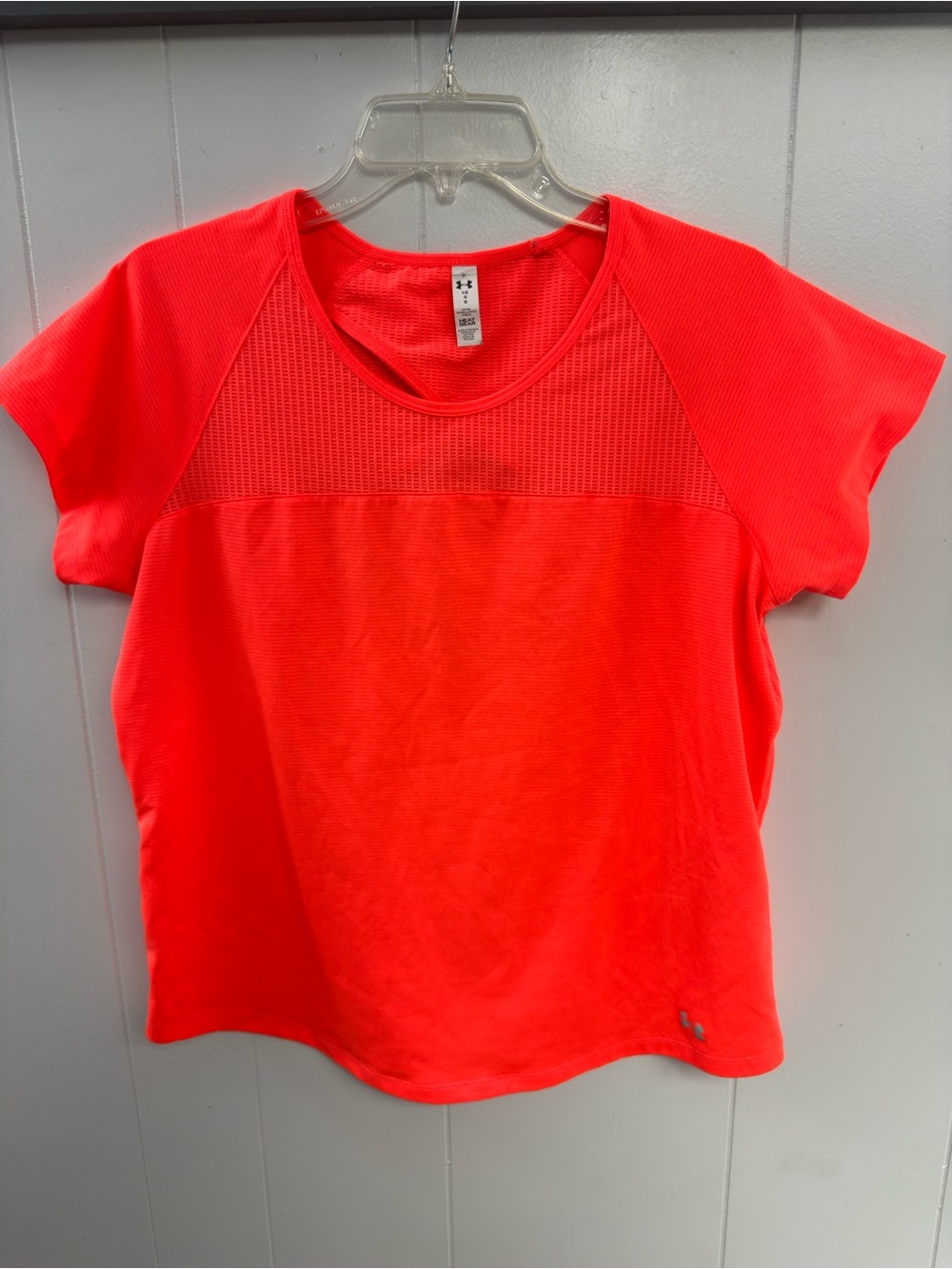 Under Armour HeatGear Performance Tee in a vibrant neon coral / orange shade.